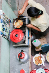 Poor latin woman cooking