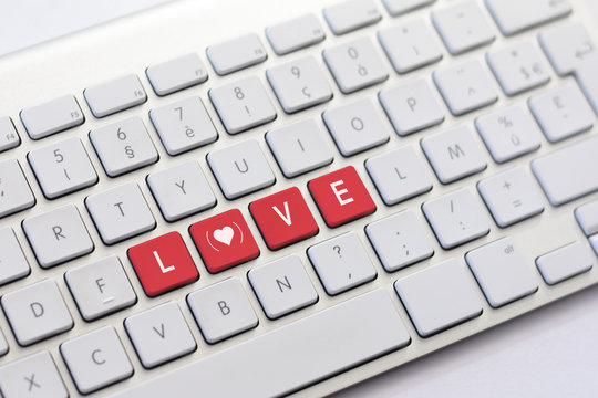 LOVE writing on white keyboard with a heart sketch with parenthe