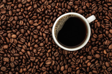 Coffee cup on beans. Top view
