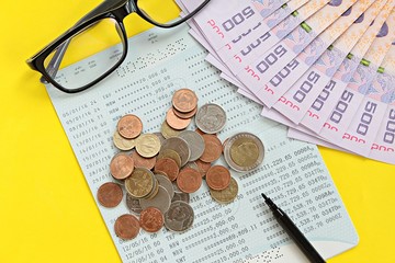 Business, finance or savings concept : Savings account passbook, Thai money baht, coins, glasses...