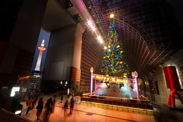 Foto op Canvas Big christmas tree with illumination light and kyoto tower at Kyoto station Japan © piyaset