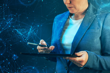 Businesswoman using mobile phone and tablet computer
