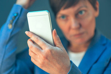 Businesswoman making selfie photo portrait with mobile phone