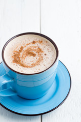 cocoa with cinnamon closeup on wooden background