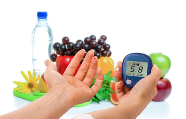 glucometer for glucose level and healthy organic food on a white background. Diabetes concept
