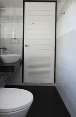 Naklejka na ściany i meble Modern new white bathroom with black tile floor