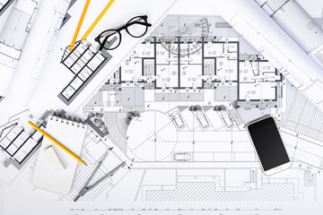 Construction plans with drawing Tools and Smart Phone on bluepri
