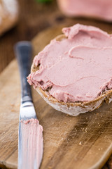Wooden table with Liverwurst Sandwich (selective focus)
