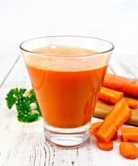 Juice carrot with vegetables and parsley on board