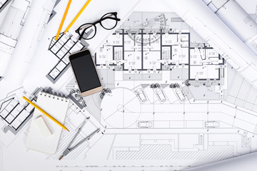 Construction plans with drawing Tools and Smart Phone on bluepri