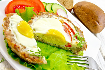 Tartlet meat with egg cut on board
