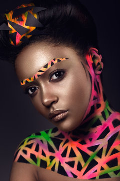 Beautiful woman with colored futuristic make up