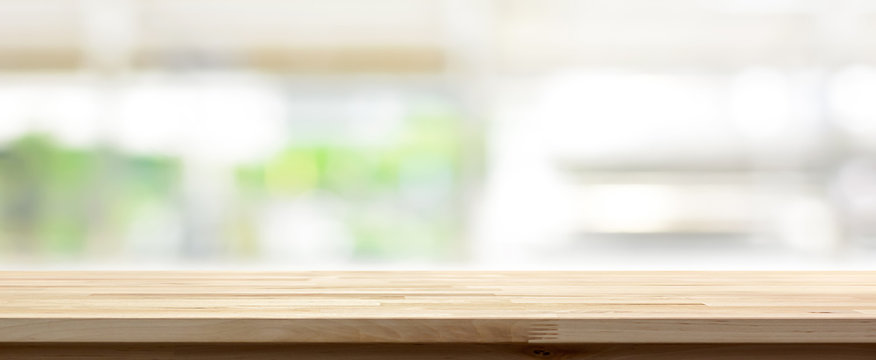 Wood table top on blur kitchen window background, panoramic bann