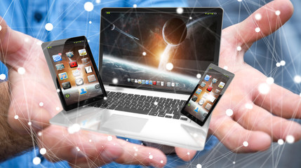 Businessman holding laptop phone and tablet in his hand 3D rende