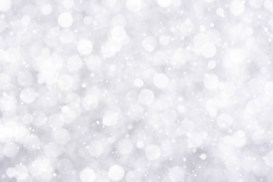 Abstract white bokeh with snowfall background
