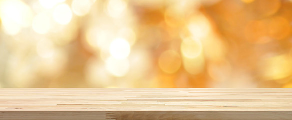 Wood table top on shiny gold bokeh abstract banner background