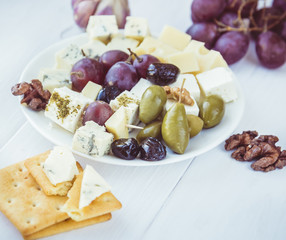 Variety of cheese with nuts and olives