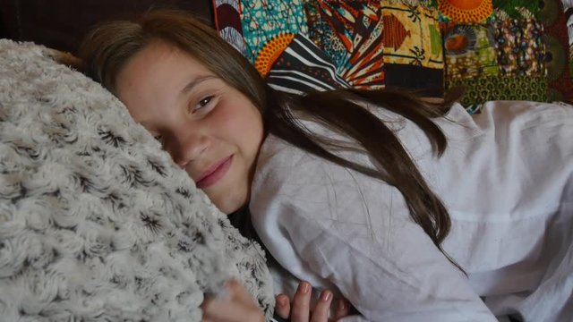 pretty young teenage girl lying on the sofa