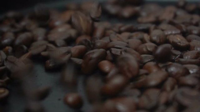 Coffee beans strewing onto the black background