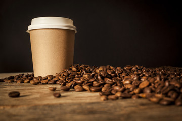 Paper cup of coffee on black background