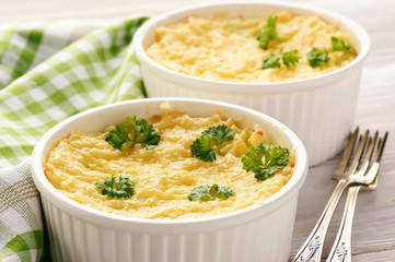 Shepherd pie on white wooden background.