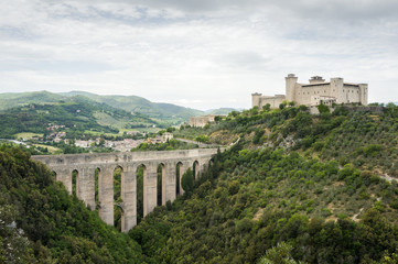 Fototapeta na wymiar The old bridge aqueduct Ponte delle Torri and the medieval fortress Rocca Albornoziana. Spoleto, Umbria, Italy.