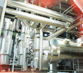 Equipment, cables and piping as found inside of a modern industr