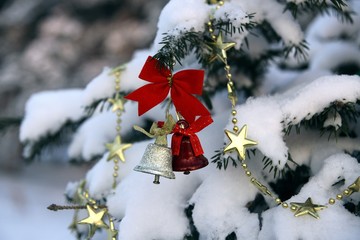 Bells on a snowy Christmas tree in the park