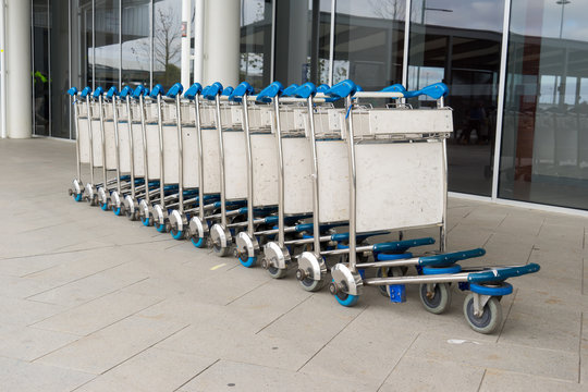 Trolleys luggage in a raw in modern airport.