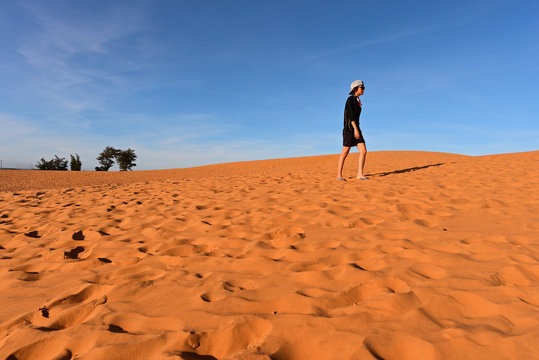 Tourist In Red Sand Dunes