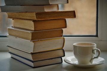 pile of old books, a cup of tea