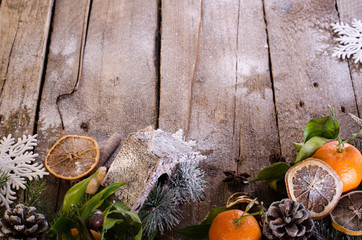 Fairy Christmas background - vintage wood, birdhouse, cinnamon, star anise, oranges, cones, snow. New Year. Top view, blank space