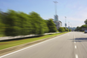 Motion blurred racetrack view on empty road asphalt