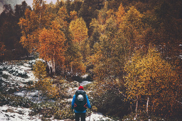 Traveler Man hiking alone autumn forest on background Travel Lifestyle adventure survival concept outdoor wild nature woods