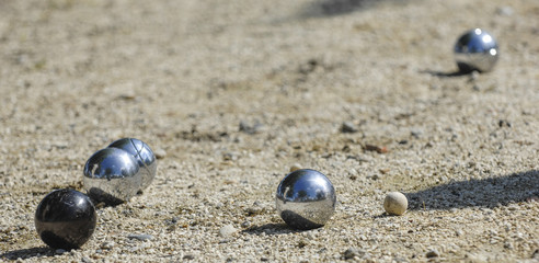Metallic petanque three balls and a small wood jack
