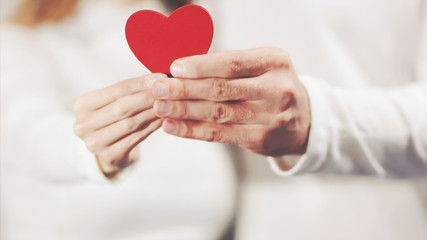 Couple in love hands holding Heart shape symbol holiday Valentines Day romantic greeting people man and woman relationship lifestyle feelings concept