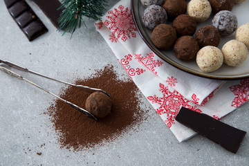 Assorted chocolate truffles with cocoa powder, coconut and chopp