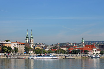 Obraz premium Danube riverside with churches buildings and boats Budapest Hung