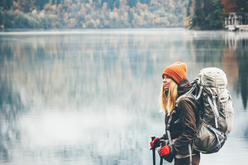 Woman with backpack hiking Lifestyle adventure concept forest and lake on background active...
