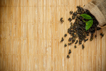 Leaves tea with sackcloth on wooden placemat