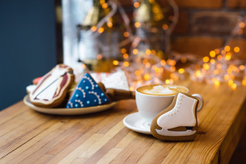 Christmas gingerbread cookie and cup of coffee at yellow festive