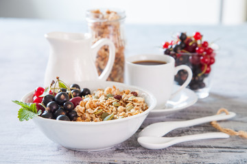 muesli with berries in a plate on a table, selective focus