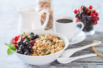 muesli with berries in a plate on a table, selective focus