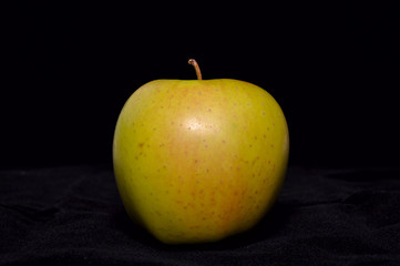 Green apple on dark background