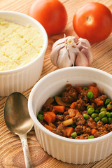Shepherd pie on wooden background. Cooking process.