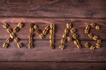 Wrote XMAS text with walnut on wooden