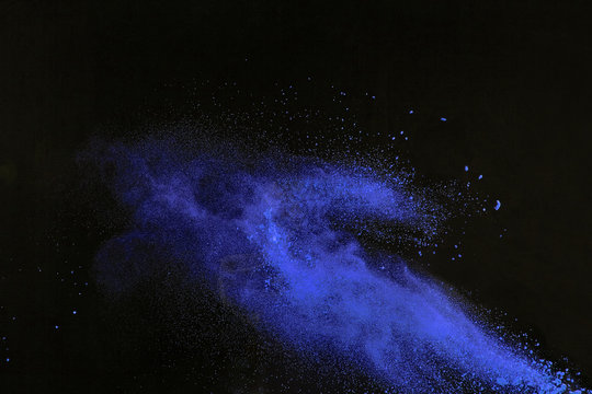 Freeze Motion Of Blue Dust Explosion Isolated On Black Backgroun