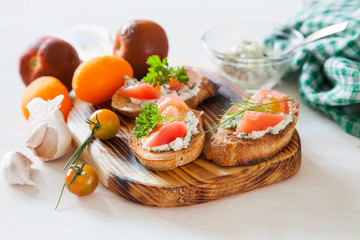 tomatoes and sandwiches on a board, selective focus