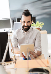 happy creative male office worker with tablet pc