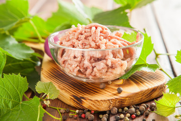 ingredients for dolma - mincemeat, onions and grape leaves on a table, selective focus